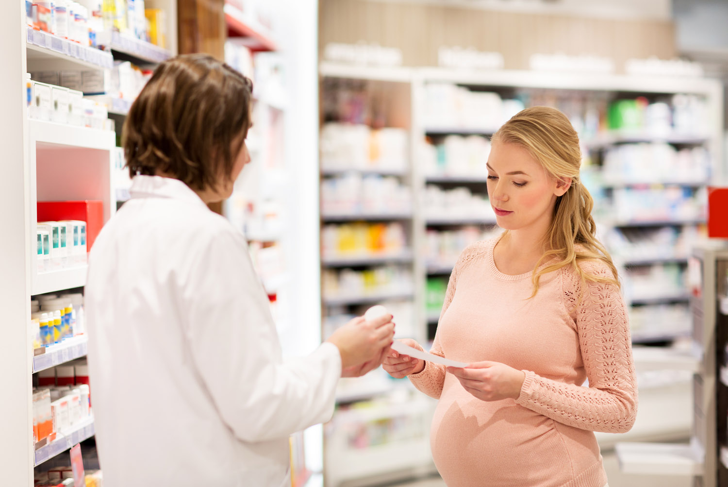 happy-pregnant-woman-and-apothecary-at-pharmacy-ppgcqph.jpg